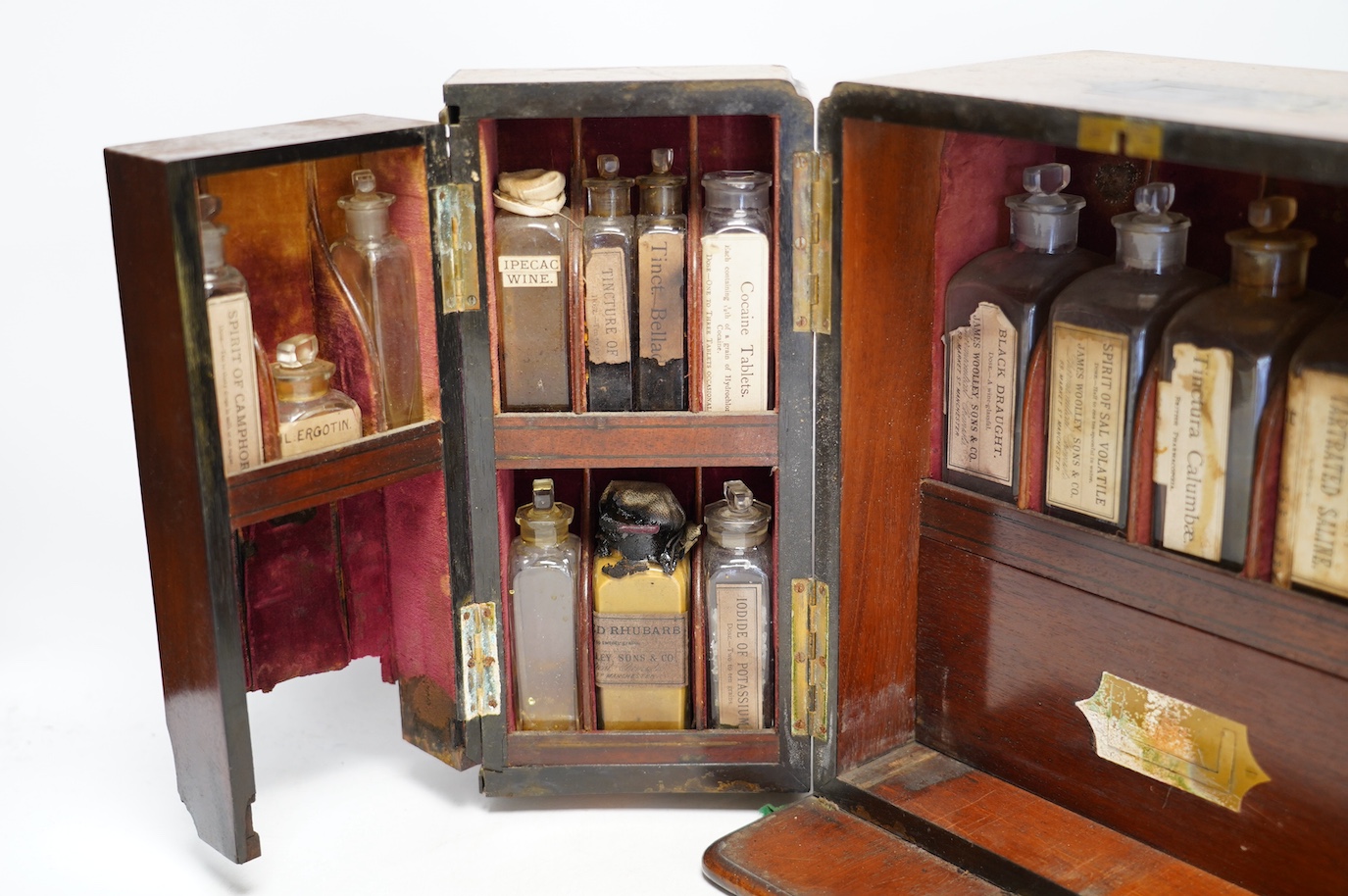 A late Victorian mahogany apothecary chest, containing a number of labelled glass bottles with preparations by James Woolley Sons and Co, Pharmaceutical Chemists, 28.5cm high, 25.5cm wide, 21cm deep. Condition - poor to